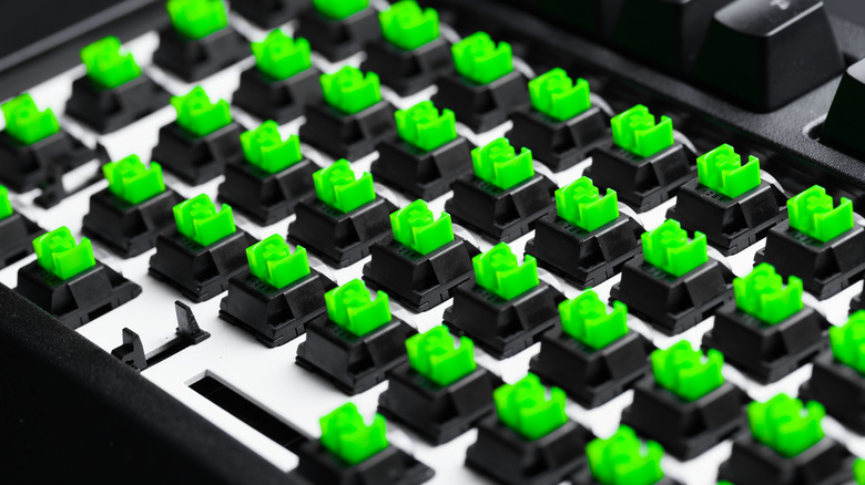 Razer keyboard with key-caps removed showing Razer Green mechanical switches