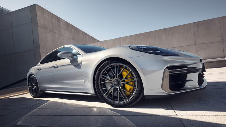 Silver Porsche Panamera parked in front of concrete walls