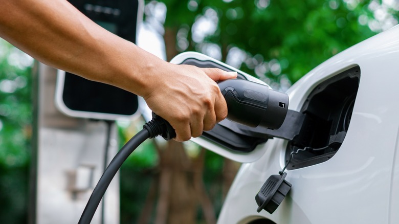 Person plugging in EV Charger