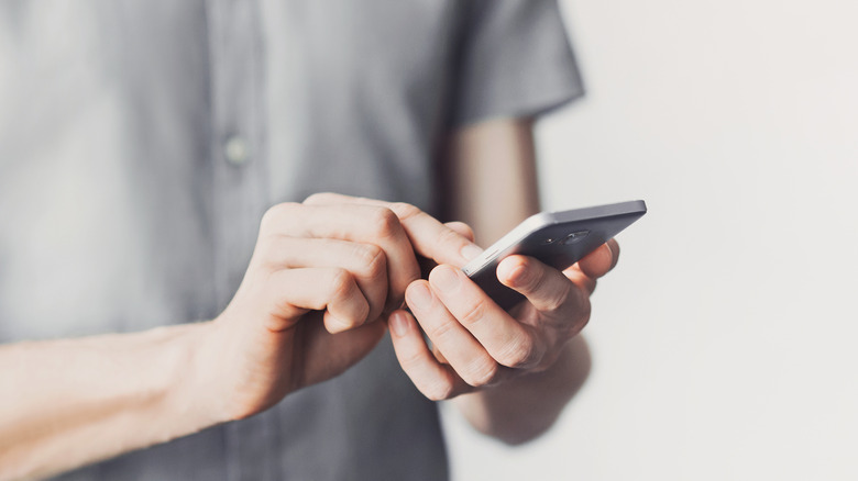man pressing on Android screen