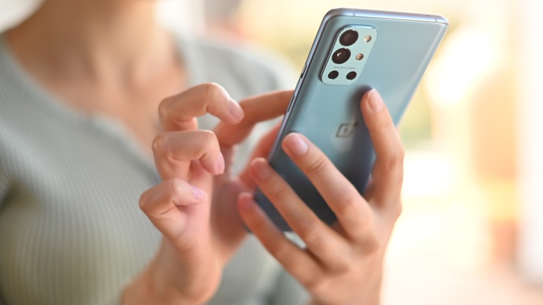 woman using oneplus 9r phone