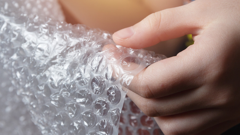 Hand popping Bubble Wrap