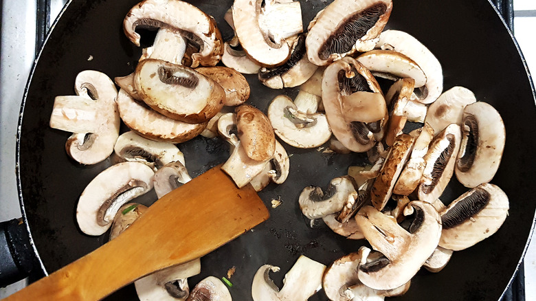 mushroom slices frying in a pan