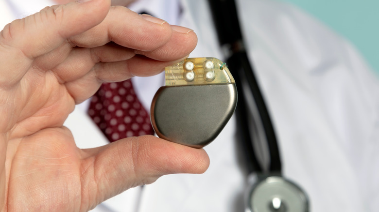 Doctor holding a pacemaker