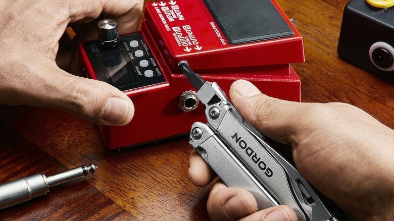 Person using Gordon Multi-tool to tighten screw on foot peddal