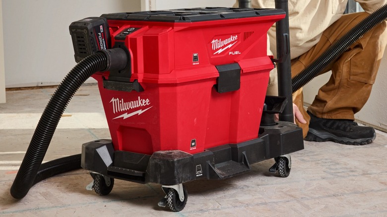 Close up of person using Milwaukee Nexus Vacuum