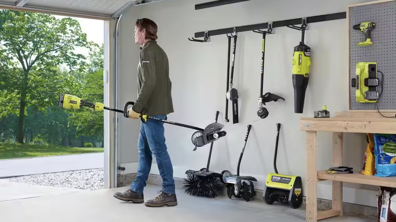 Man walking away with Ryobi tool in hand