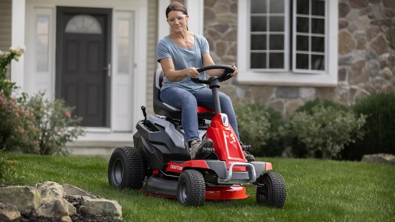 A woman using a Craftsman 56V MAX electric riding mower