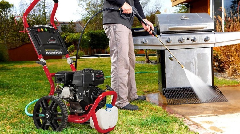 person using pressure washer