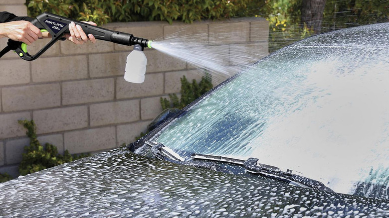 person using pressure washer
