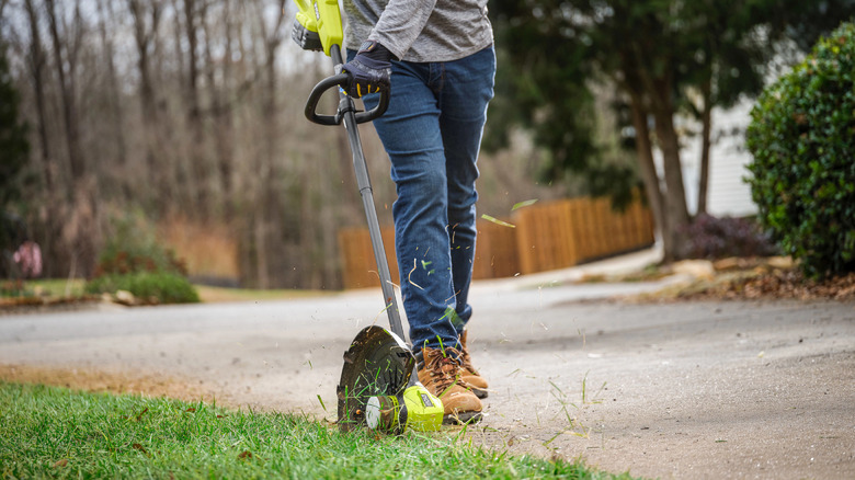 Person using string trimmer as an edger