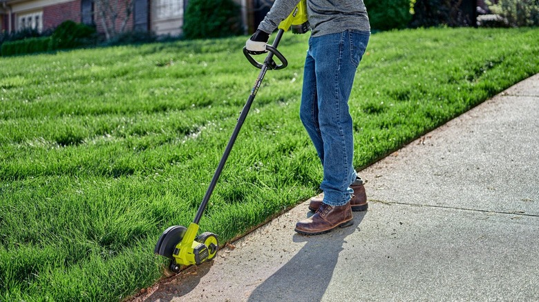 Person using edger on yard