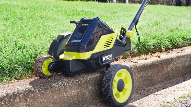 Edger cutting alongside curb