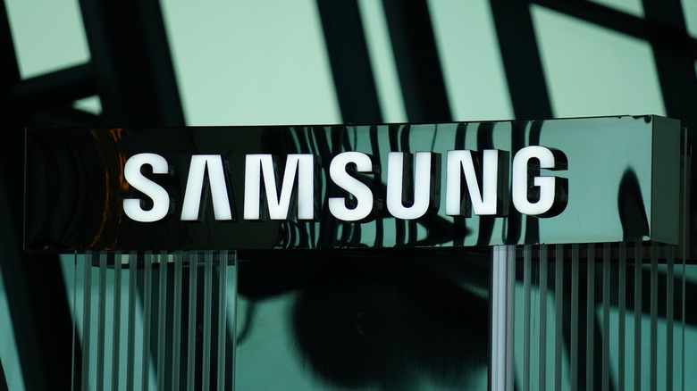 A white Samsung logo on a shiny green background