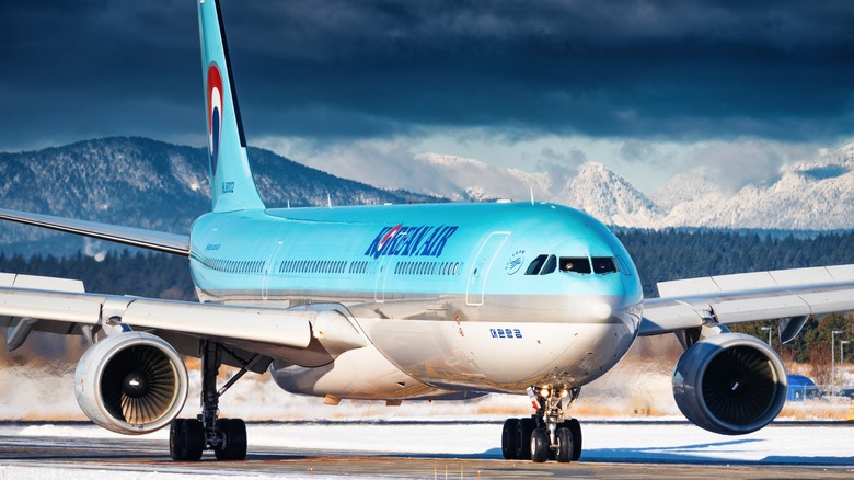 Airbus A330 flying under Korean Air, taxing at gates