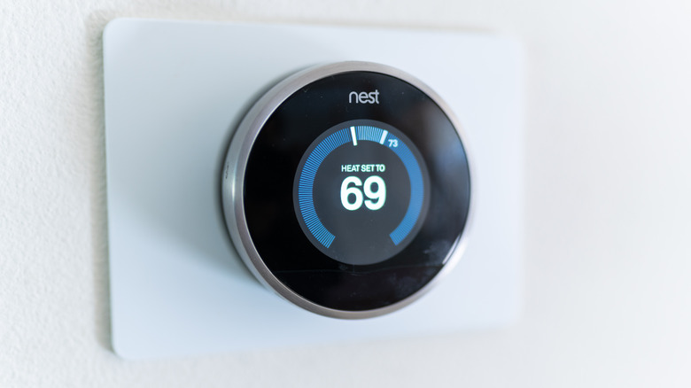 Wall mounted smart thermostat set to cool home