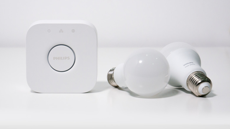 Philips hue smart bulbs and hue bridge sitting on white background