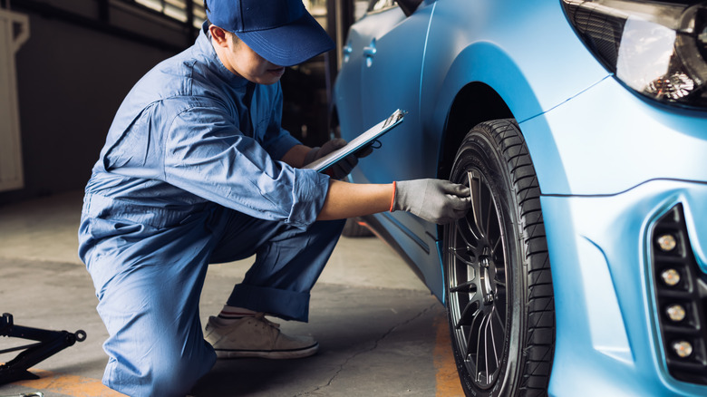 mechanic airing a tire