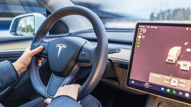 View of a Tesla steering wheel and infotainment screen