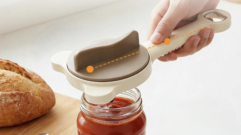 Hand uses Jar Opener on tomato sauce jar