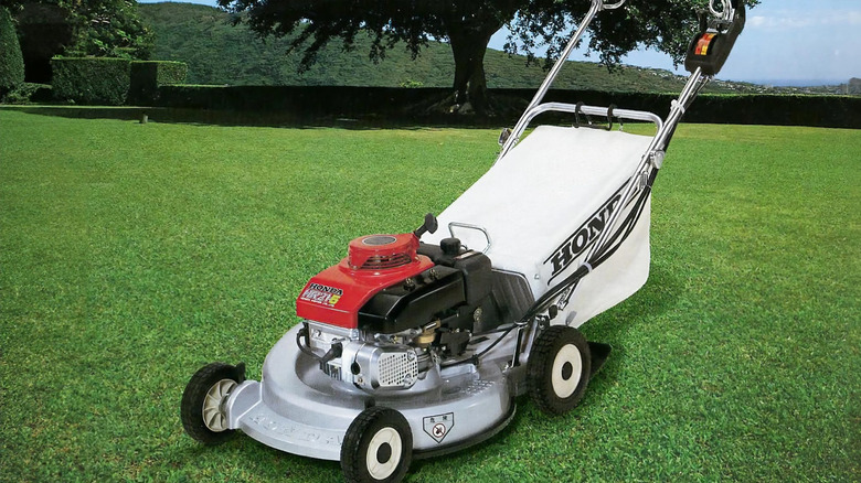 A classic Honda lawnmower rests on a lawn