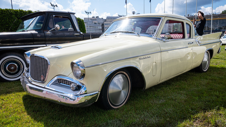 A white Studebaker parked at car show