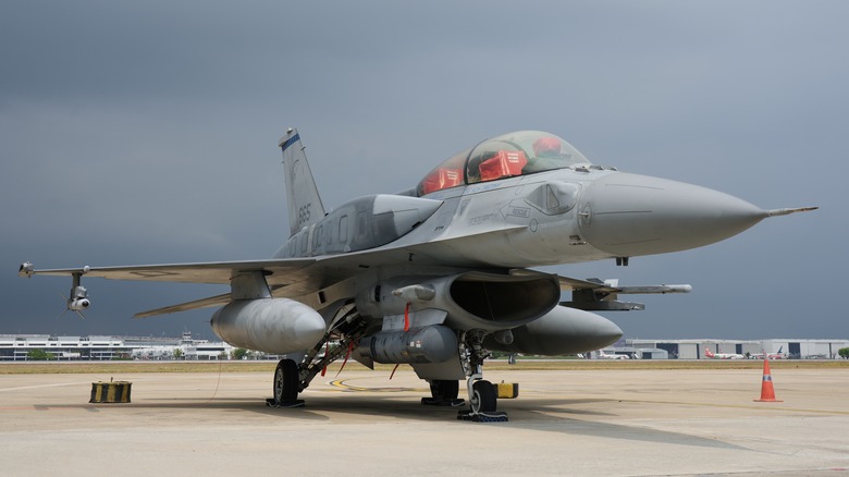 F-16 parked on a runway with overcast skies