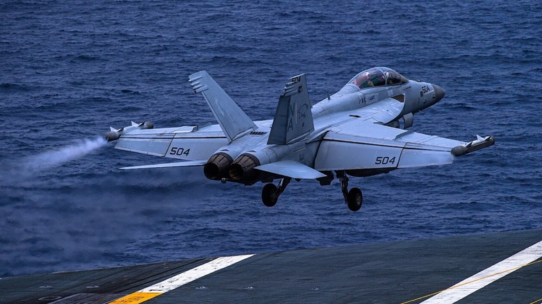 An EA-18G Growler takes off from an aircraft carrier.