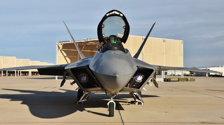An Air Force F-22 Raptor fighter jet with its canopy open on a runway at Davis-Monthan Air Force Base