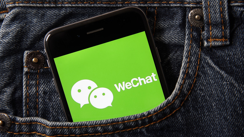 WeChat logo on a phone in a jeans pocket