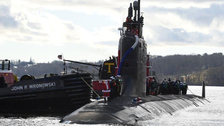 The USS Colorado prepares to moor during a homecoming event at a Naval Submarine Base