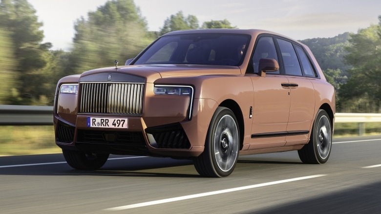 Front 3/4 action view of a Rolls-Royce Cullinan Black Badge Series II