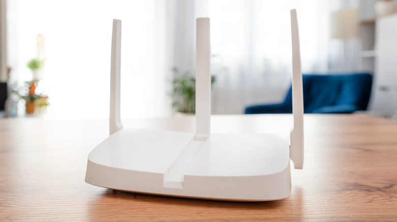 A Wi-fi router on a wood table.