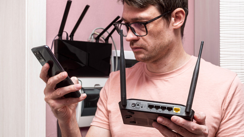 Man configuring a wireless router