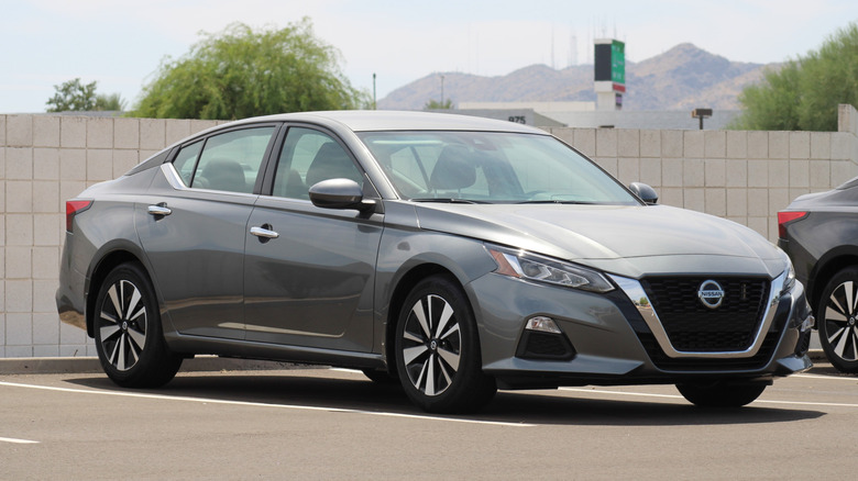 Gray Nissan Altima sedan parked on dealer lot