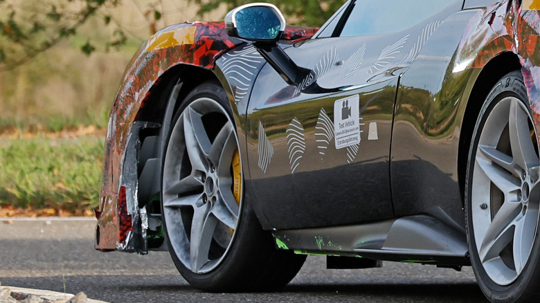A close-up spy shot of a reported Ferrari 296 Challenge Stradale's side skirts.