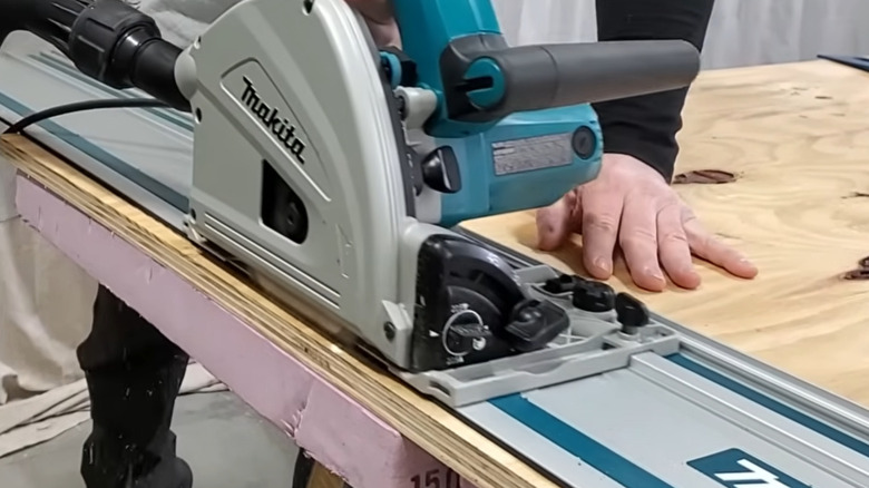 A man using the Makita corded track saw