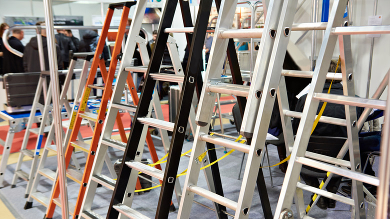 A variety of ladders sitting next to each other