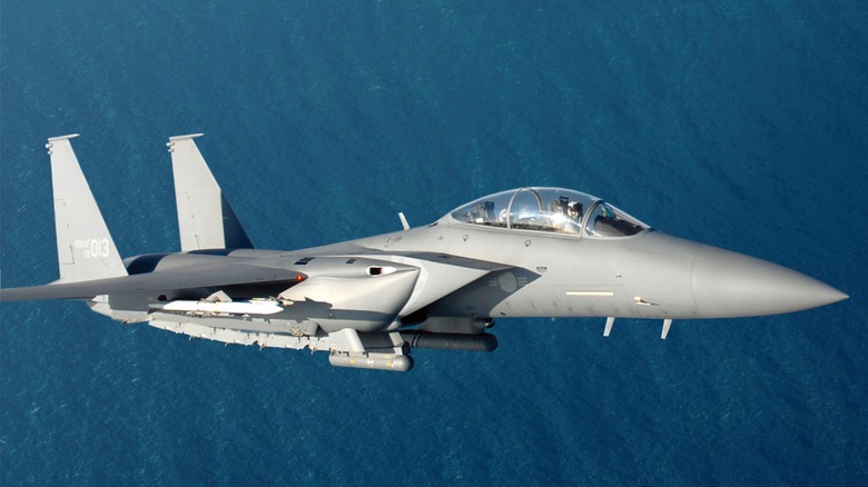 A ROKAF F-15K flying over the ocean, side view