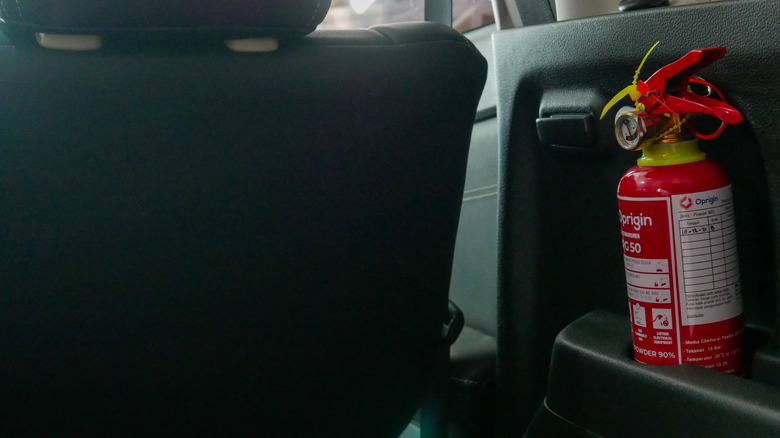 A small fire extinguisher tucked in a car's rear.