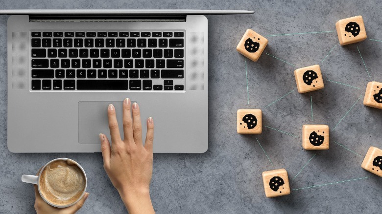 laptop with cookie icons on table