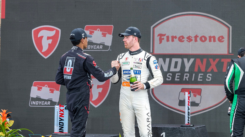Drivers shaking hands at IndyCar podium ceremony