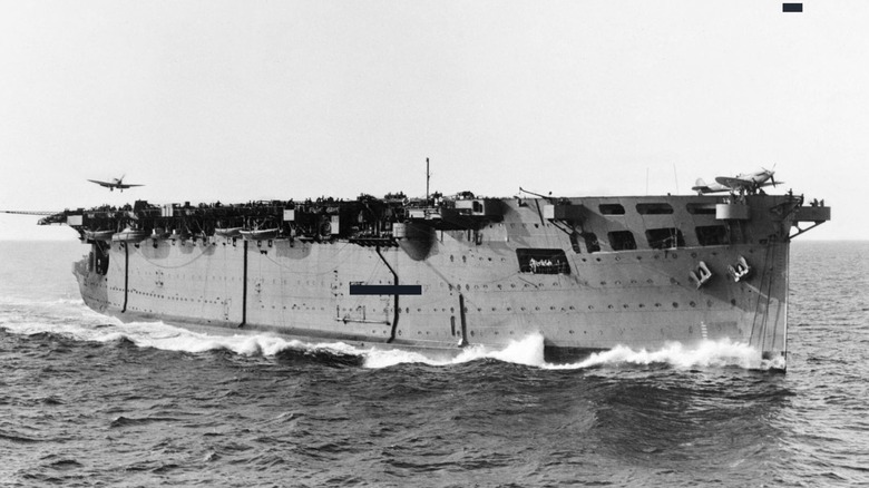 HMS Argus at sea with plane inbound
