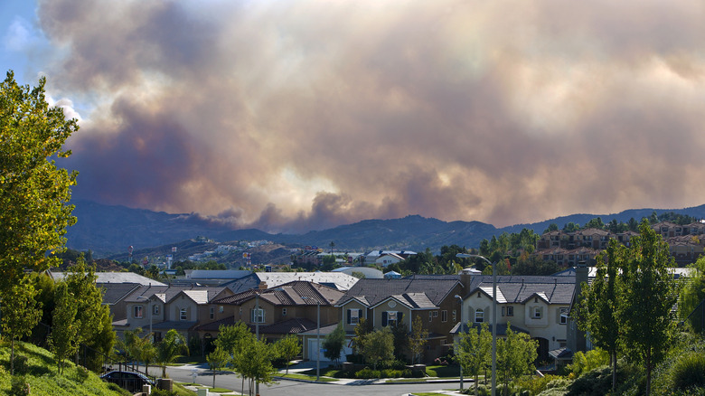 Dense smoke from wildfires above houses on Los Angeles street