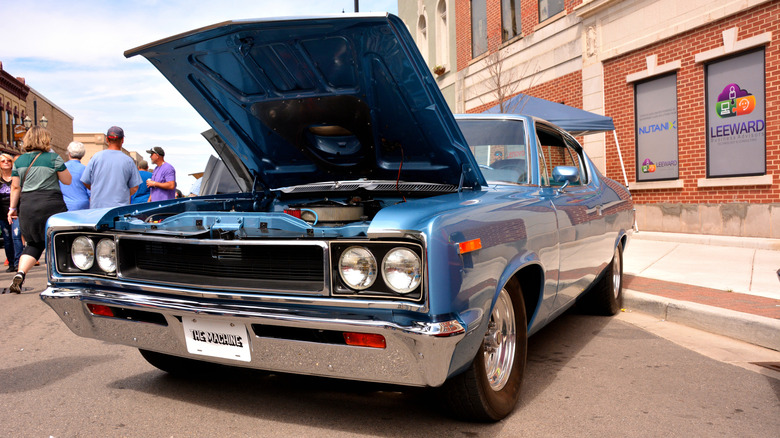 A front-end view of a AMC Rebel Machine with its hood open.