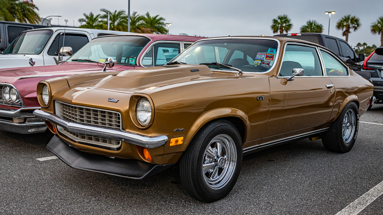 A brown Chevrolet Vega GT parked near other cars in an outdoor parking lot.