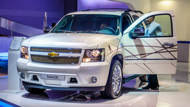 A 2012 Chevrolet Tahoe presented at a car show with its doors open.