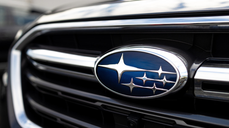 A close-up of a car's front grille featuring the Subaru badge.