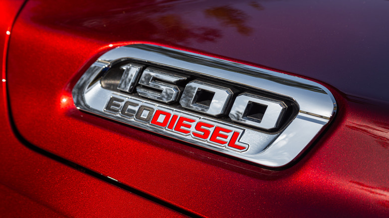 A close-up of a red Ram truck wearing a 1500 EcoDiesel badge.