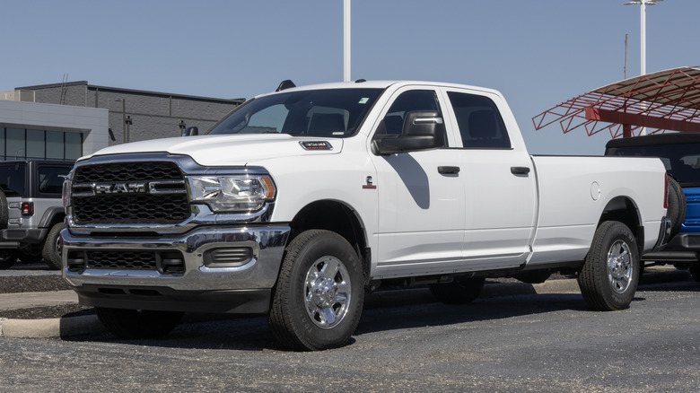 A white heavy-duty Ram truck parked in an industrial setting.